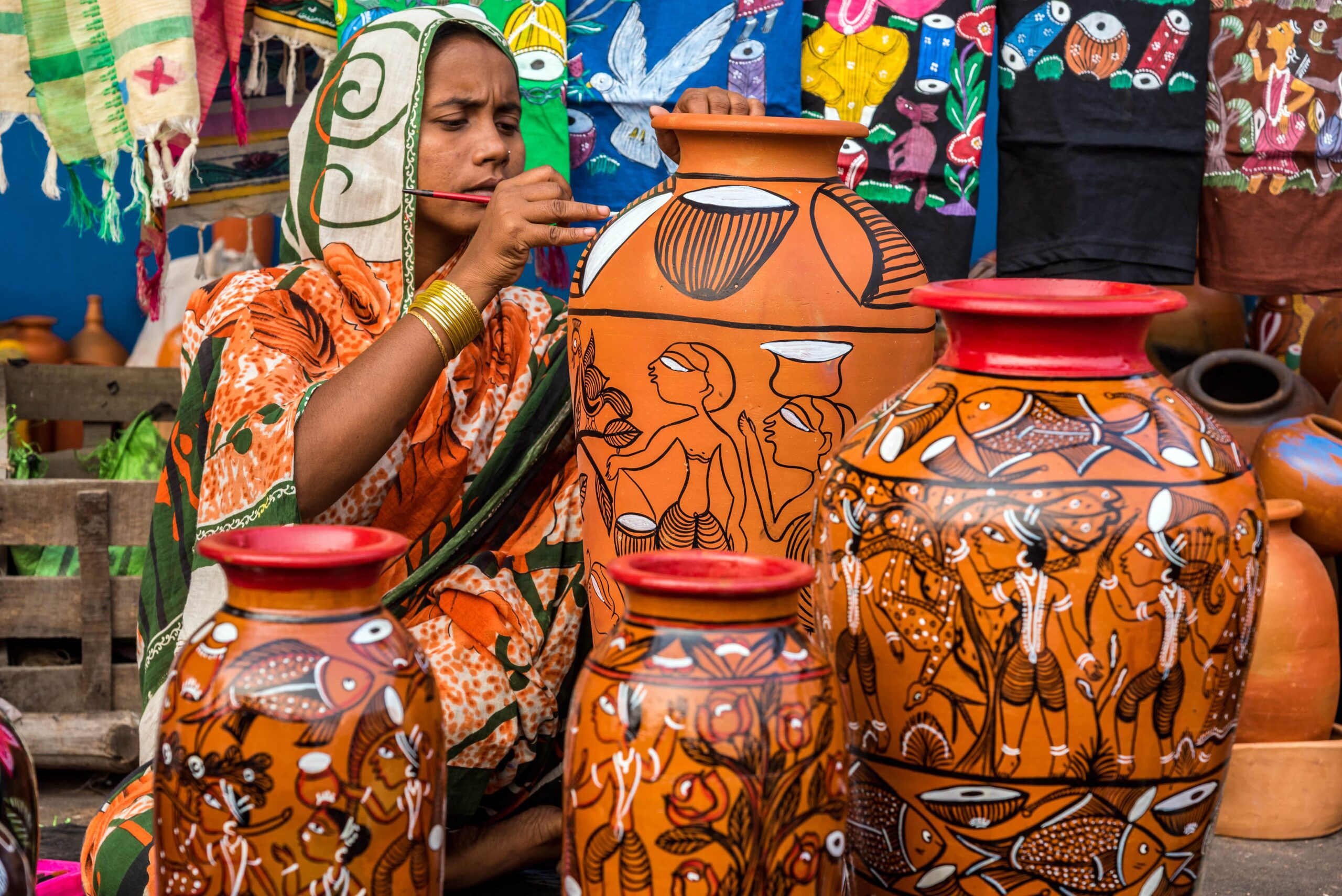 Woman artisan painting a pot